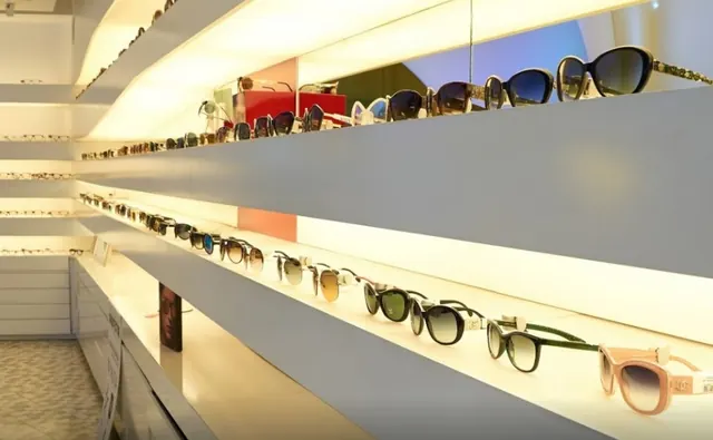 Estantes lacados en blanco con gafas expuestas e iluminación