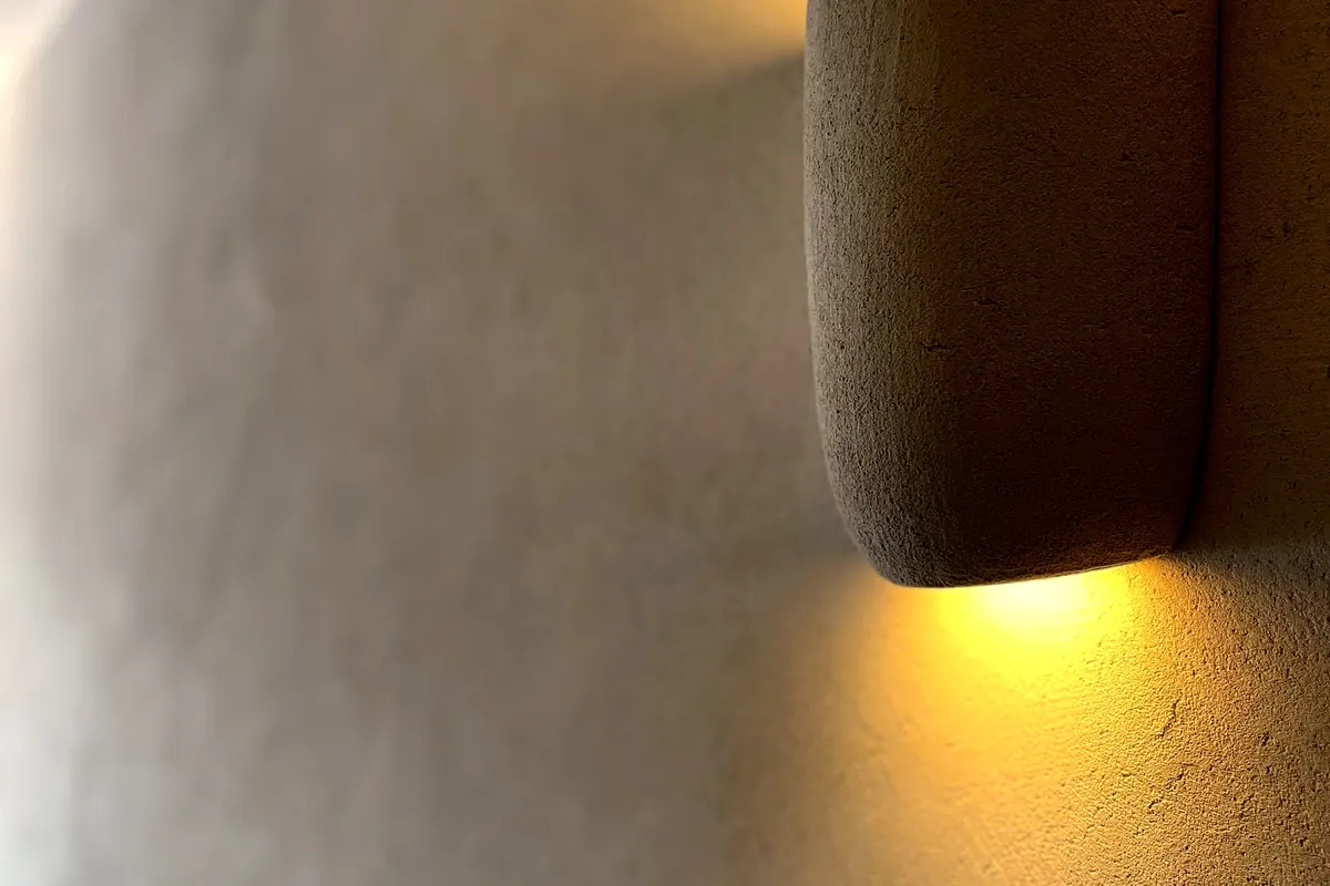 Pared de cal iluminada por un aplique, acabado mate