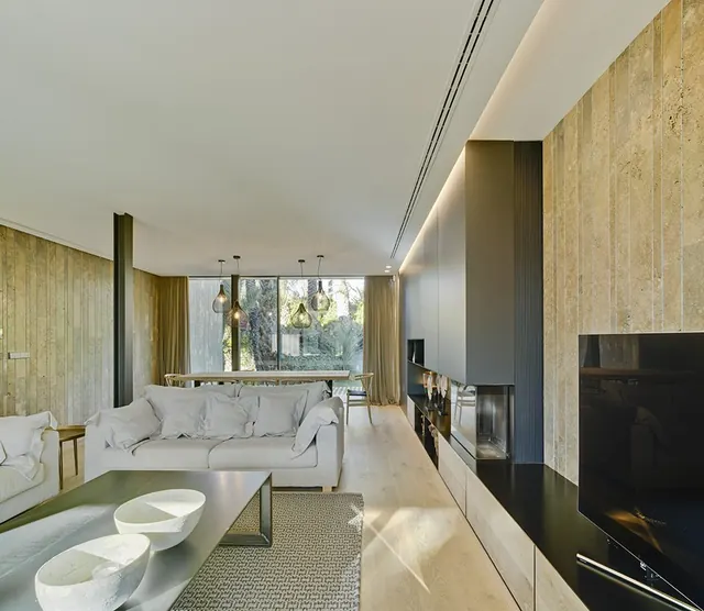 Salón con chimenea y revestimiento de madera en la pared